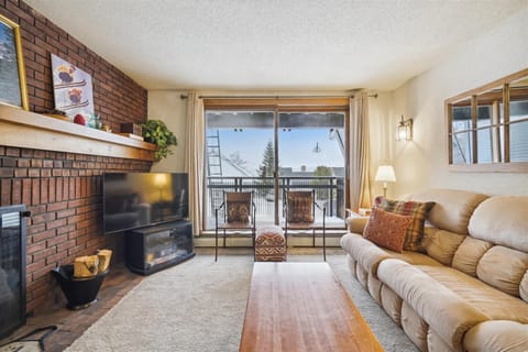 Relax on the couch, and enjoy watching the flatscreen tv.