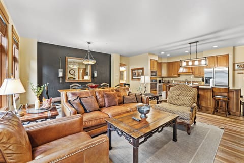 Unwind in your elegant open-concept living space with rich leather seating and gourmet kitchen.