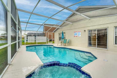 Private screened pool and spa with patio seating, perfect for relaxing and enjoying outdoor Florida living.
