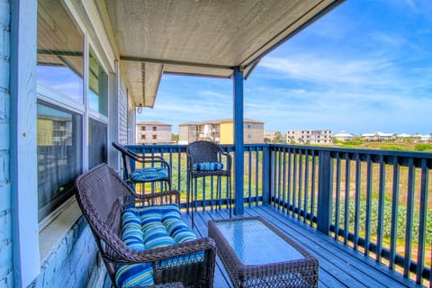Unwind on your private balcony with comfortable wicker seating and colorful cushions, perfect for morning coffee or evening relaxation.