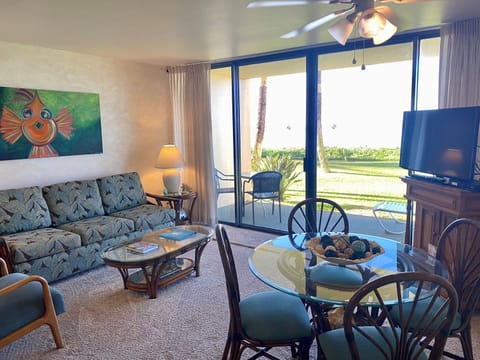 Settle into your comfortable living space with coastal charm, bright natural light, and a private patio overlooking lush green surroundings—perfect for relaxing after a day of island adventures.