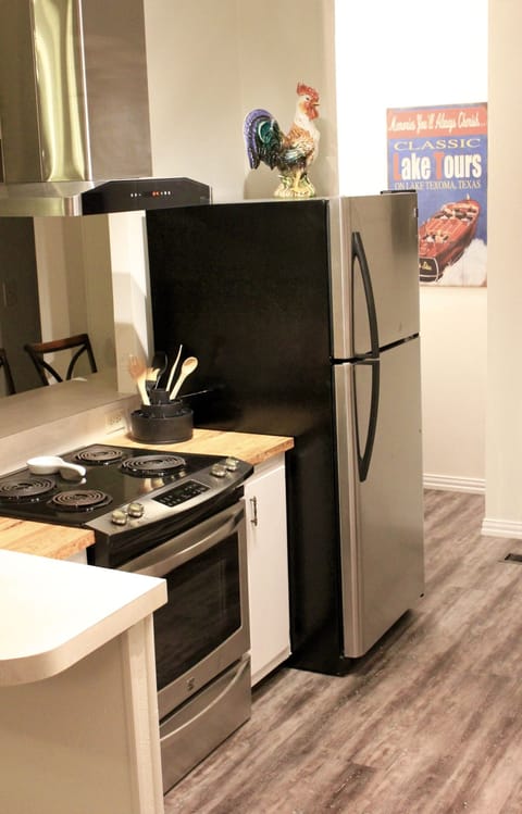 Kitchen stove & frig. Full size washer and dryer in the corner.