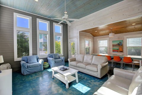 Relax in this bright open living space with soaring ceilings, comfortable seating, and modern touches throughout.