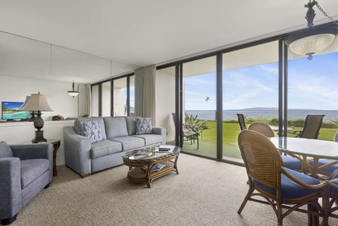 Relax in your bright, airy living space where floor-to-ceiling windows frame stunning ocean views. Sink into comfortable seating and enjoy the seamless indoor-outdoor flow to your private lawn and waterfront.