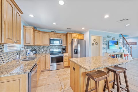 Experience kitchen luxury with stunning granite countertops, rich wooden cabinets, and top-of-the-line stainless steel appliances.
