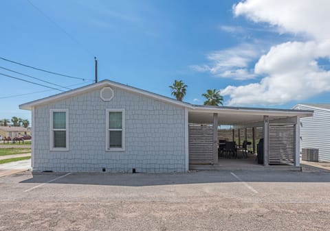 Charming coastal cottage with covered patio and parking in a peaceful neighborhood setting.