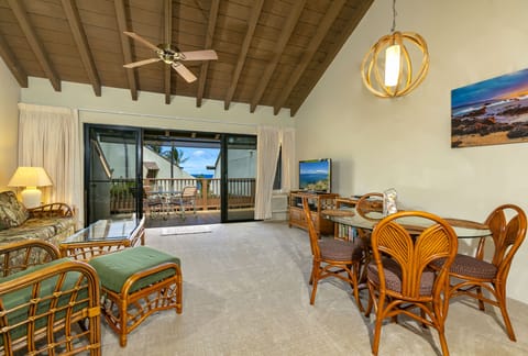 Step into your tropical retreat, where vaulted wood ceilings frame inviting living and dining spaces. Slide open the doors to your private deck with stunning ocean views just beyond.