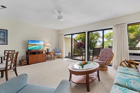 Your bright, tropical-themed living area opens to a lush patio, where you can relax and soak in island vibes surrounded by swaying palms.