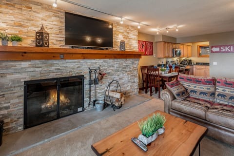Relax in front of the stacked stone fire place. 