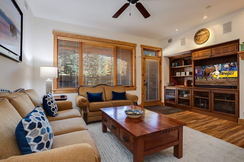 Unwind in your stylish living room with plush seating and built-in entertainment center perfect for cozy evenings.