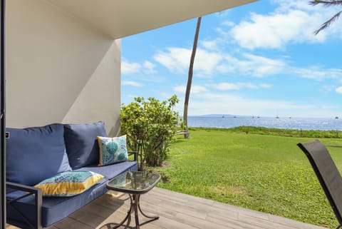 Settle into your private covered patio with comfortable seating and breathtaking oceanfront views. The lush lawn stretches to the sparkling sea, inviting peaceful mornings and serene sunsets.