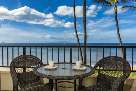 Sip your morning coffee on your private balcony overlooking azure waters and swaying palms, with distant islands dotting the horizon under tropical skies.