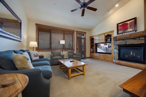 Settle into your cozy living space with plush seating, a warm fireplace, and mountain-lodge charm perfect for evenings after adventure-filled days.