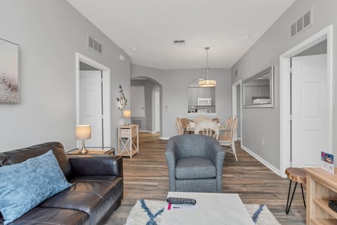 Cosmopolitan Coziness: Retreat to our townhouse living area, a cozy space designed for relaxation and entertainment in a stylish setting