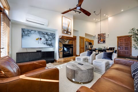Unwind in your luxurious living space with rich leather seating, crackling fireplace, and mountain adventure on the big screen.