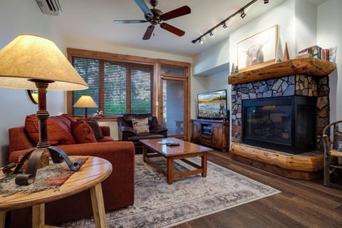 Cozy up by your stone fireplace while enjoying the warm glow of rustic wood furnishings and mountain-inspired décor.