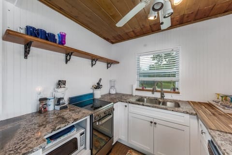 Custom Wood Shelving, Granite Countertops, and Stainless Steel Appliances