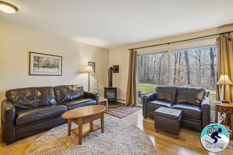 Living room with plenty of seating for your small group. Propane stove to enjoy and warm up after those cold days or just to add some ambiance to your evening. Tons of natural light from your slider door access to back yard and small patio.