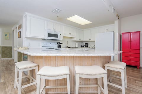 Gather around the stylish kitchen breakfast bar, perfect for coffee and conversations in a welcoming space