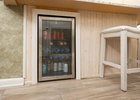 Enjoy refreshing beverages from the sleek mini-fridge, conveniently located near the stylish bar seating