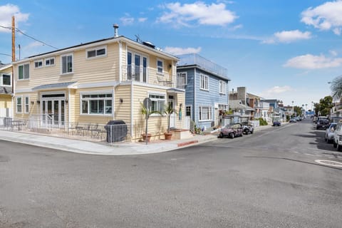 Charming beachside neighborhood with colorful homes and palm trees under sunny California skies.