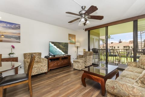 Sink into comfort in your island-inspired living room, where a private balcony and ceiling fan create the perfect tropical retreat for relaxing after a day of adventure.