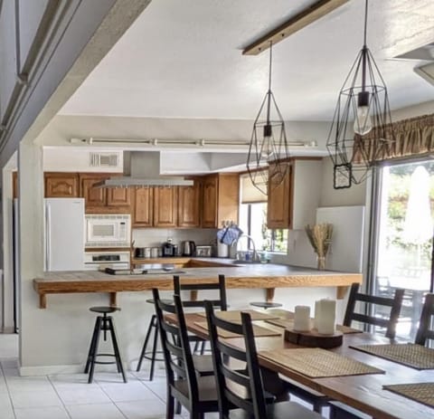 The bright open kitchen has bar seating for4 and a farm table ready for up to 6