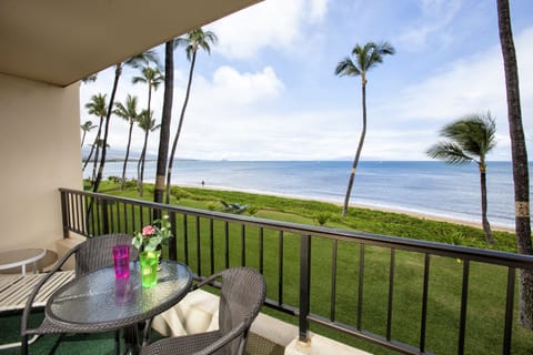 Sip morning coffee from your private oceanfront balcony, where swaying palms frame endless sea views and gentle waves meet soft green lawns—pure island tranquility awaits.