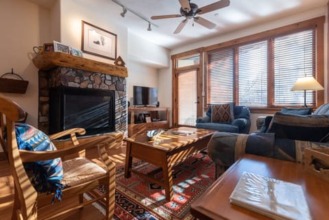 Cozy up by your stone fireplace where warm sunlight filters through your windows, creating the perfect mountain retreat atmosphere.