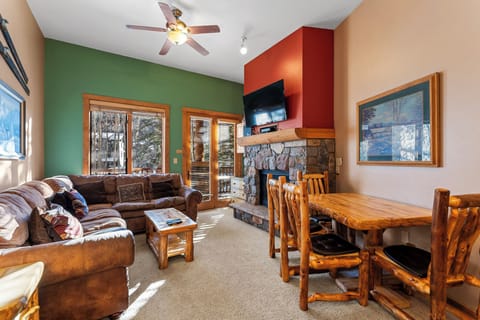 Unwind in your cozy mountain retreat where leather sofas and rustic log dining set the perfect scene for memorable evenings by the crackling stone fireplace.