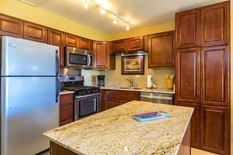 Prepare your favorite meals in this well-equipped kitchen with stainless appliances, granite countertops, and rich cherry cabinetry—everything you need for a comfortable stay.