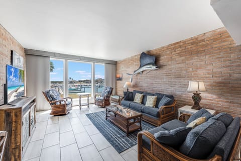Relax in your coastal living room with stunning marina views, wicker furniture, and nautical décor creating the perfect waterfront escape.