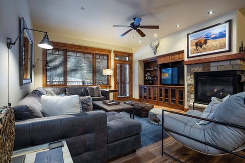 Sink into plush sofas by your crackling fireplace, where rustic charm meets modern comfort in your mountain retreat.