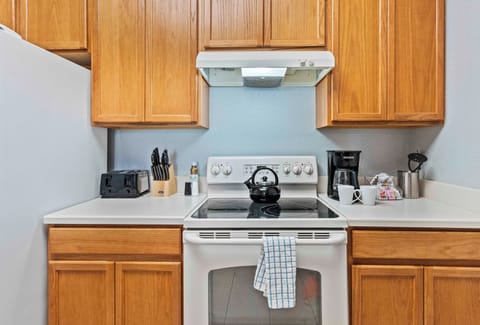 The kitchen adorned with wooden cabinets exudes rustic elegance, blending natural charm with modern functionality for a warm and inviting culinary space.