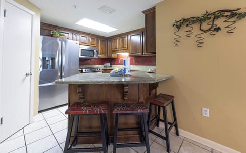 Gather around the stylish kitchen bar area, perfect for casual meals and enjoying drinks together