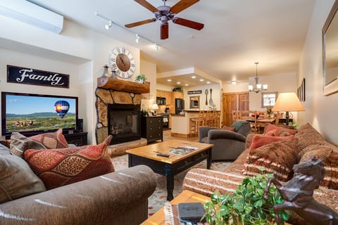 Sink into plush sofas by your stone fireplace while dinner sizzles in the open kitchen—perfect for family memories.