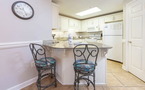 Gather around the stylish bar seating to enjoy meals and conversations in this inviting kitchen space