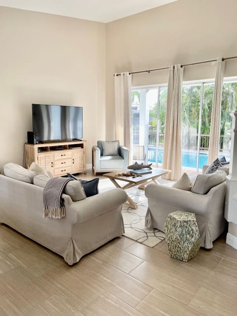 Living Room with Vaulted Ceilings opening to the pool and waterfront.