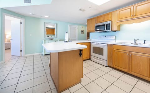 Cook and gather in this inviting kitchen with ample counter space and a cheerful color palette for a delightful stay