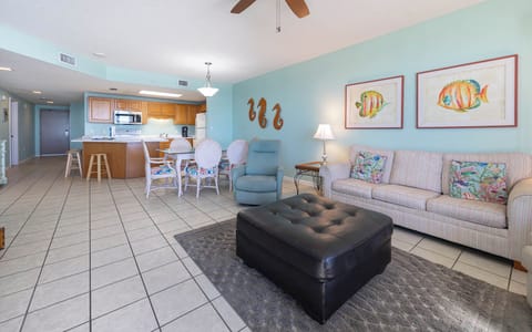 Unwind in the spacious living area featuring colorful decor, sofa with queen sleeper, and a welcoming atmosphere