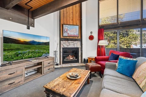 Living area with gas fireplace and recent updates including large smart tv.