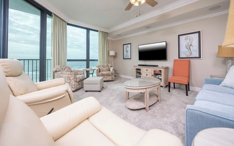 Relax in this inviting living area with a sofa and queen sleeper, a flat-screen TV, and beautiful views through large windows