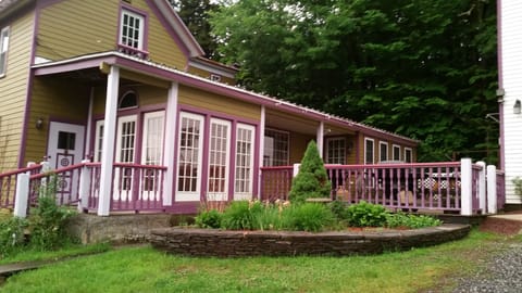 The back deck has a BBQ grill and 3 large picnic tables..