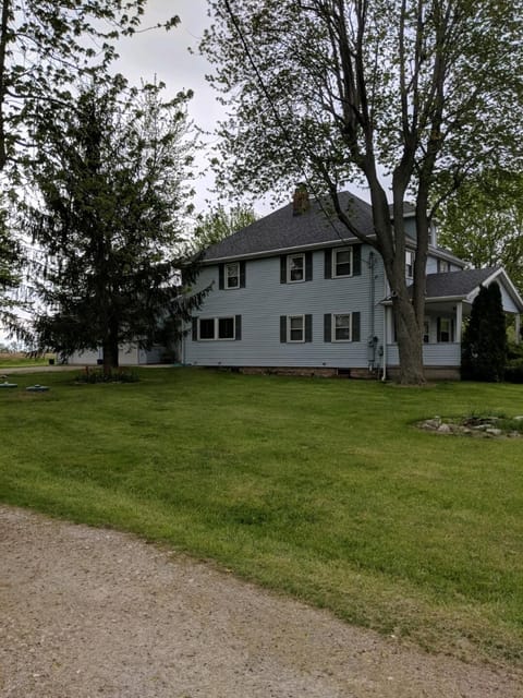 View from end of driveway. Large farmhouse with ample outdoor space