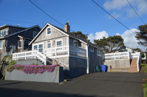 Front view of cottage with new large asphalt driveway just recently installed.