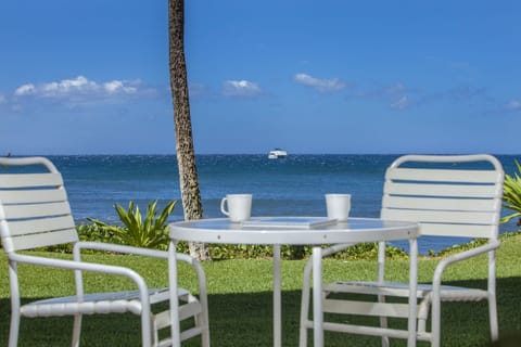 Sip your morning coffee at this waterfront seating area, where calm turquoise waters meet a bright blue sky. A perfect spot to watch boats drift by.