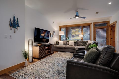 Sink into plush leather seating while you enjoy your favorite shows on the large TV in this stylish living room.