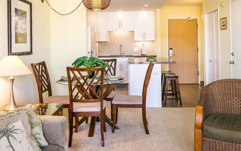 Step into your bright, cozy space where the living area flows into a fully equipped kitchen—perfect for home-cooked meals or quick snacks between beach trips.