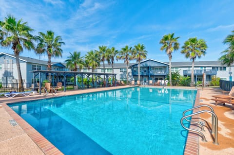 Dive into crystal-clear waters surrounded by swaying palms and comfortable loungers—your perfect poolside retreat awaits.