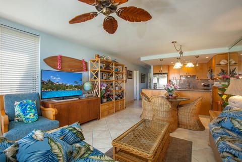 Relax in your bright, tropical-inspired living space featuring island décor, woven furnishings, and a fully equipped kitchen perfect for gathering with loved ones.